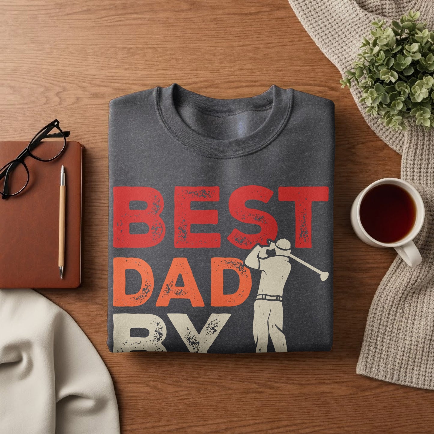 Dark gray sweatshirt with "BEST DAD EVER" in red and white with a golfer graphic.