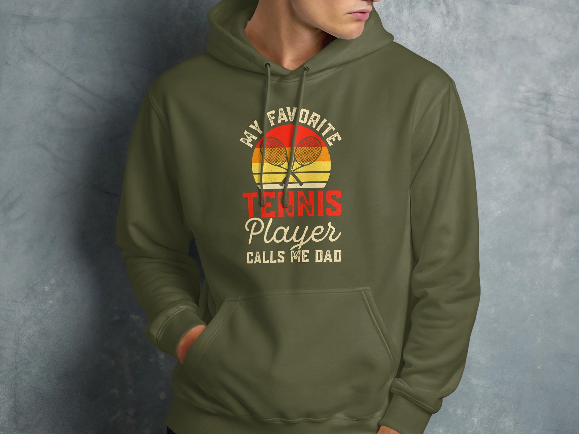 Green hoodie with "My Favorite Tennis Player Calls Me Dad" text and rackets.