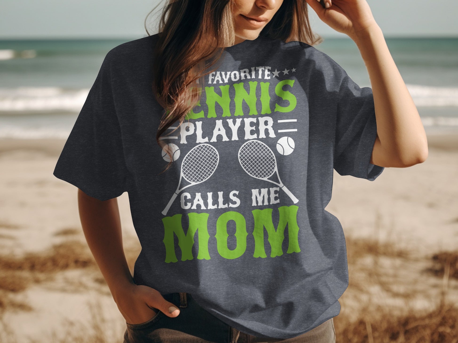T-shirt with "Favorite Tennis Player Calls Me Mom" text and tennis racquets.