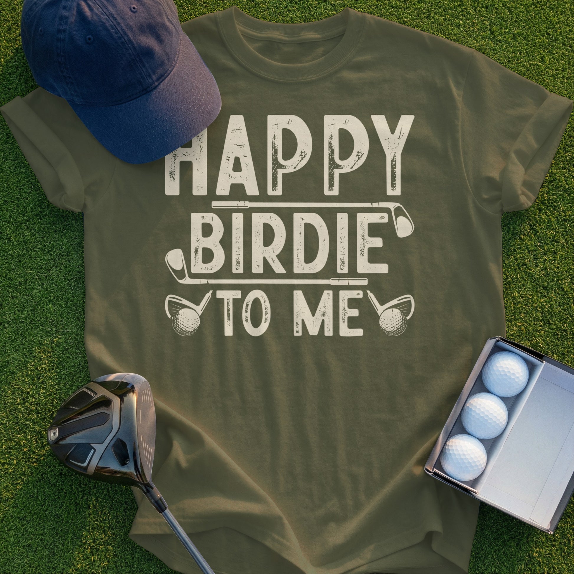 Olive green t-shirt with "Happy Birdie To Me" text, golf clubs, and golf balls.