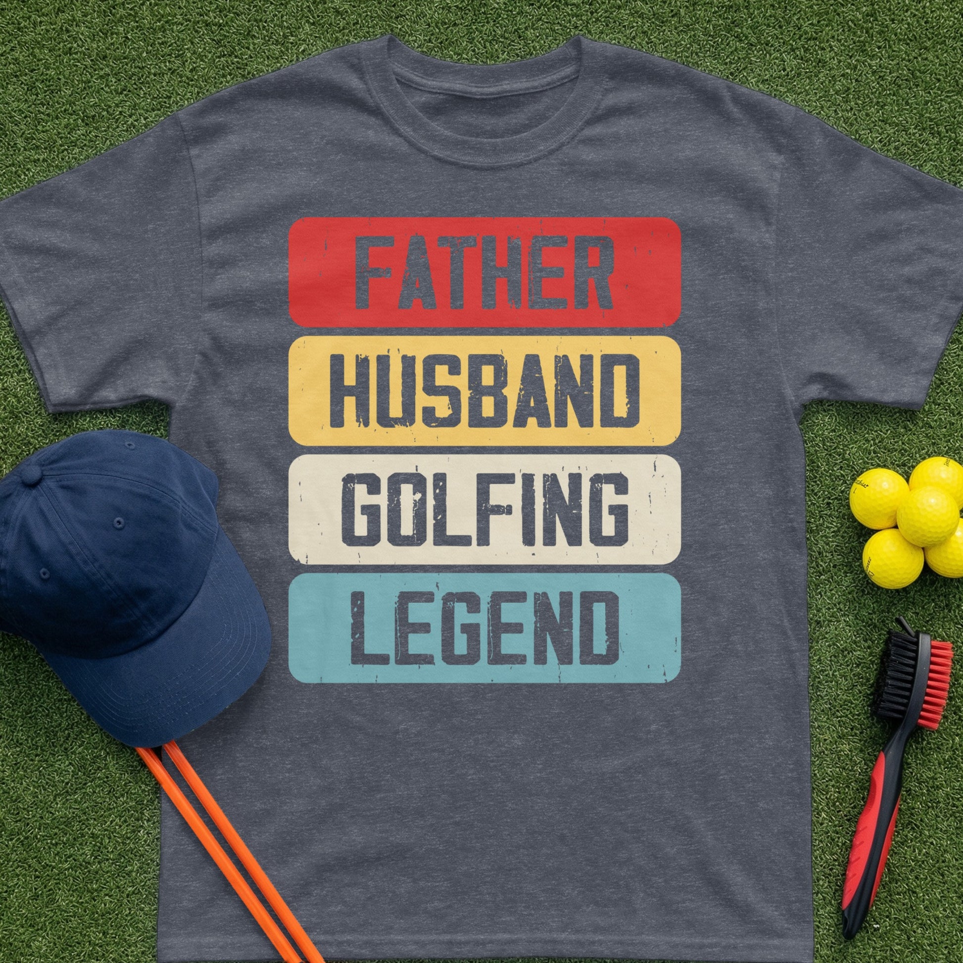 T-shirt reading "Father Husband Golfing Legend" on a grassy background.