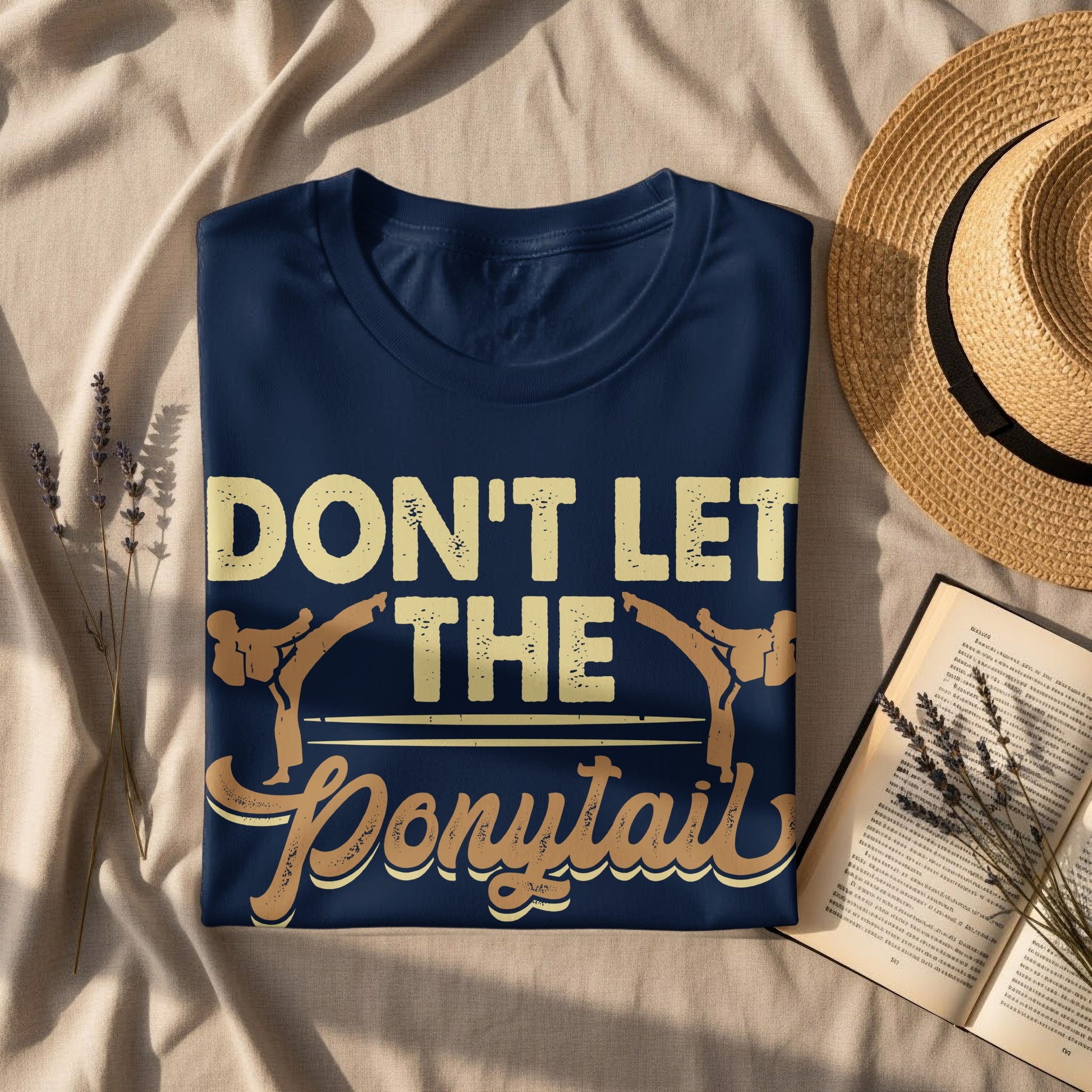 Navy t-shirt with text "DON'T LET THE Ponytail" and martial arts graphic.