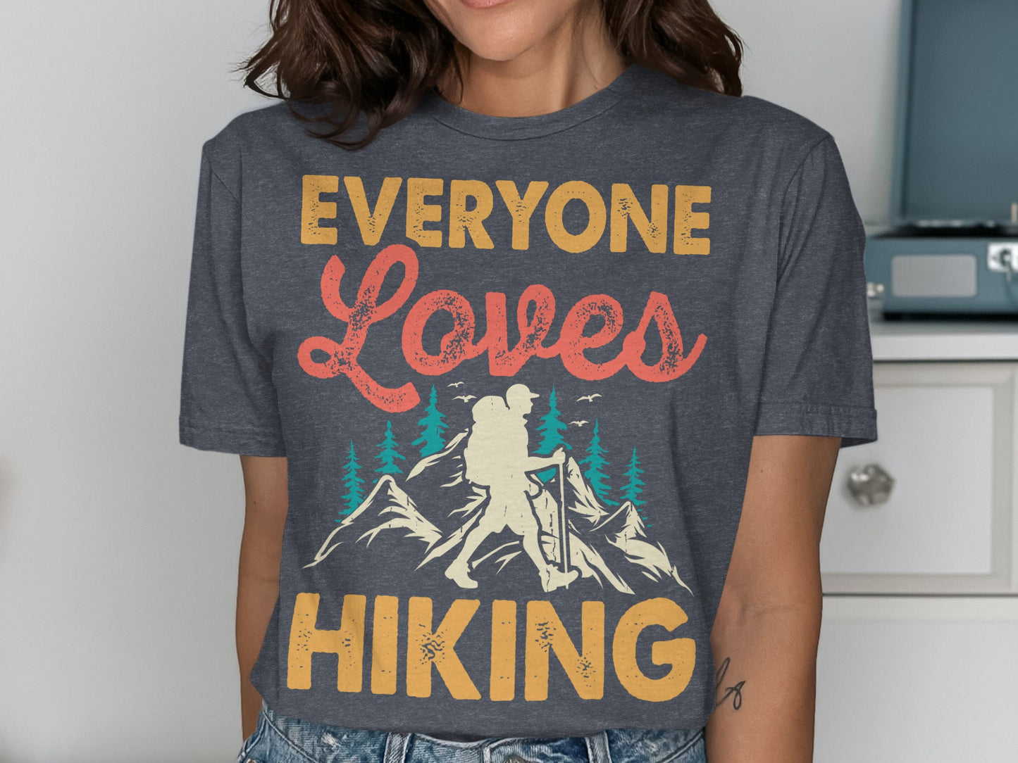 Dark grey t-shirt with "Everyone Loves Hiking" and mountain graphic.