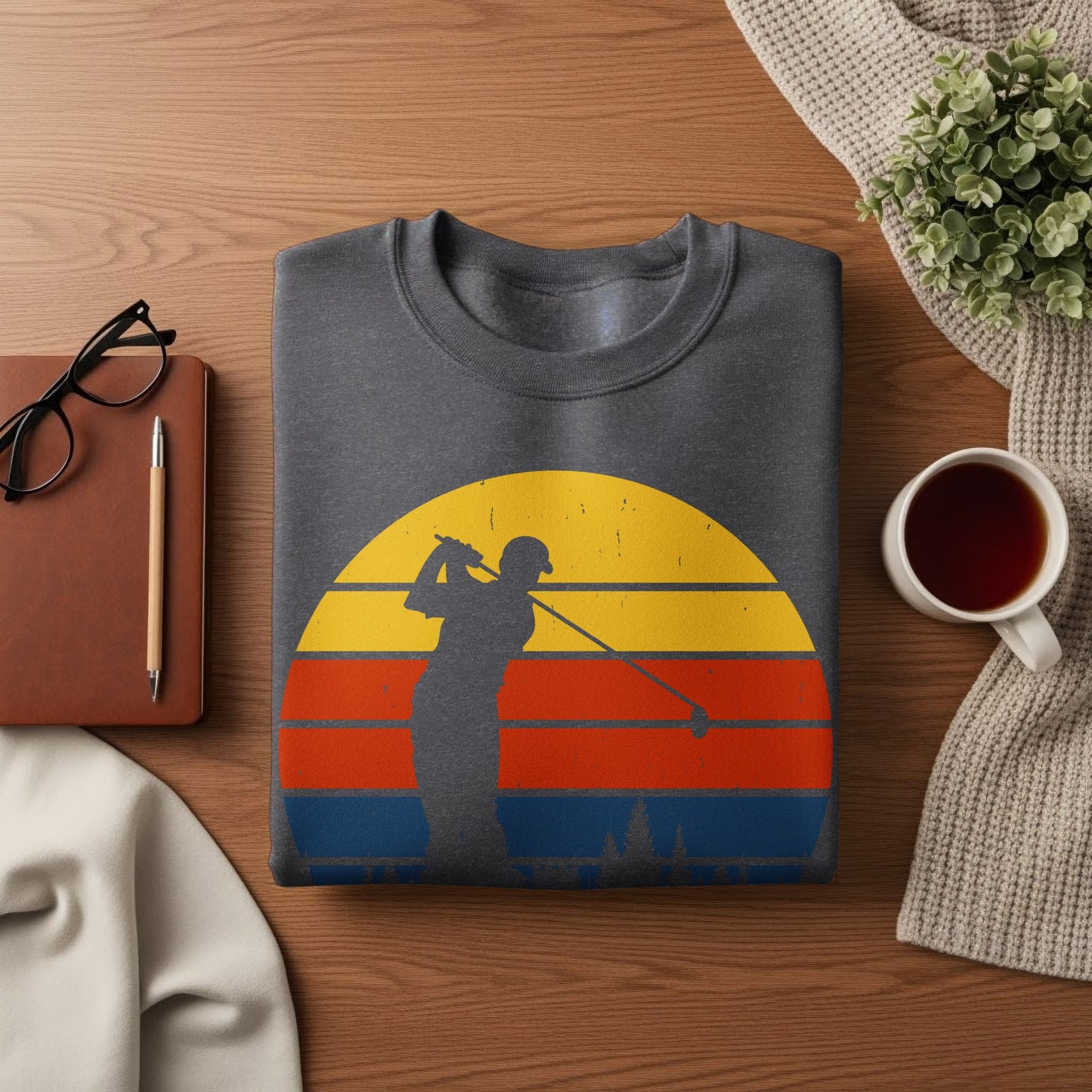 Dark gray sweatshirt with a vintage sunset golf graphic and trees.