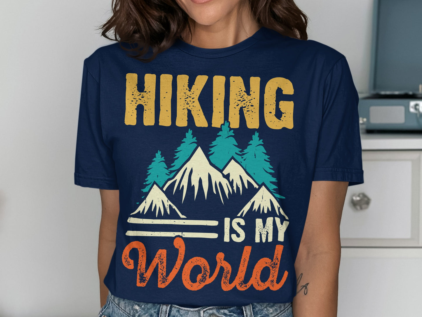 T-shirt with mountains, trees, and text "Hiking is my World".