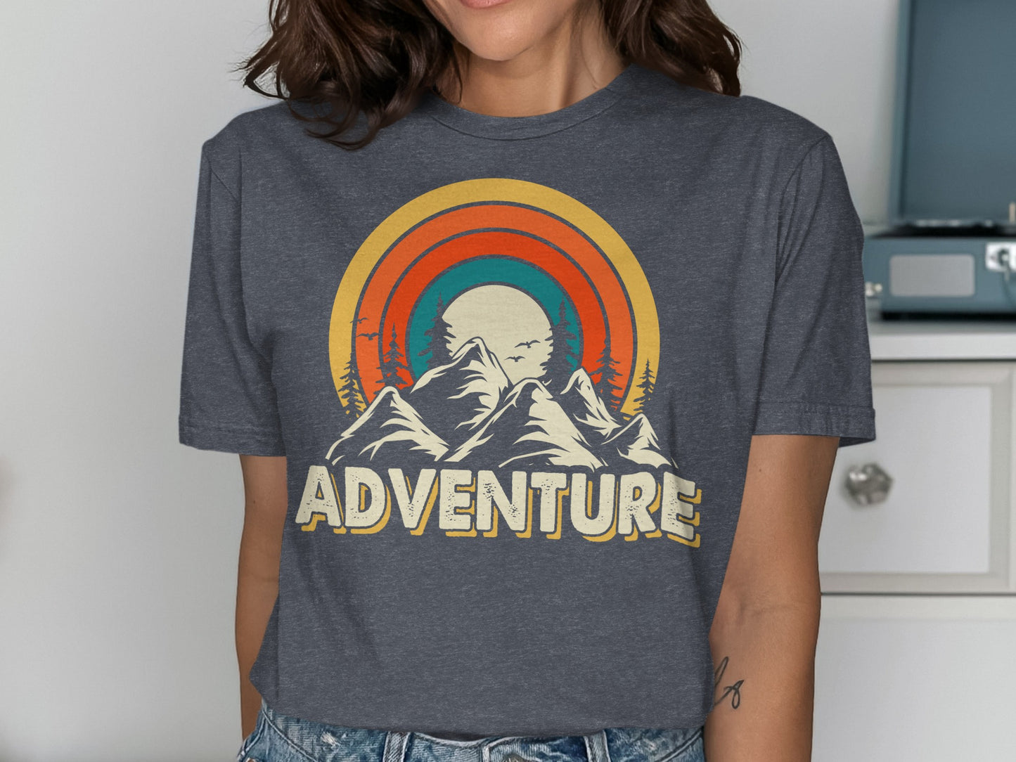 Grey t-shirt with mountain range, sunset, and "ADVENTURE" text.