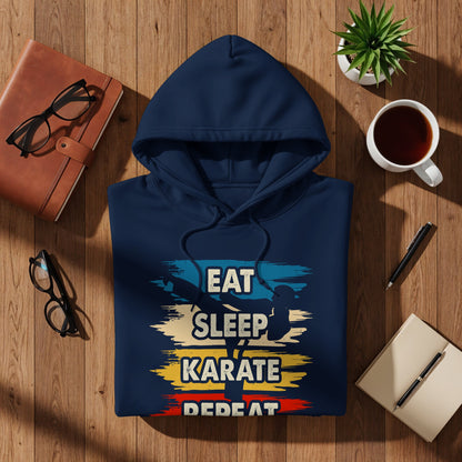 Navy blue hoodie with "Eat Sleep Karate Repeat" graphic on wooden surface.