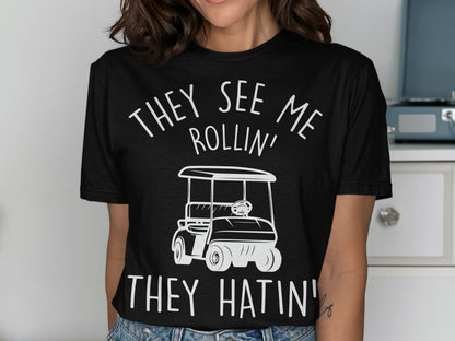 Black t-shirt with white text and graphic of a golf cart.