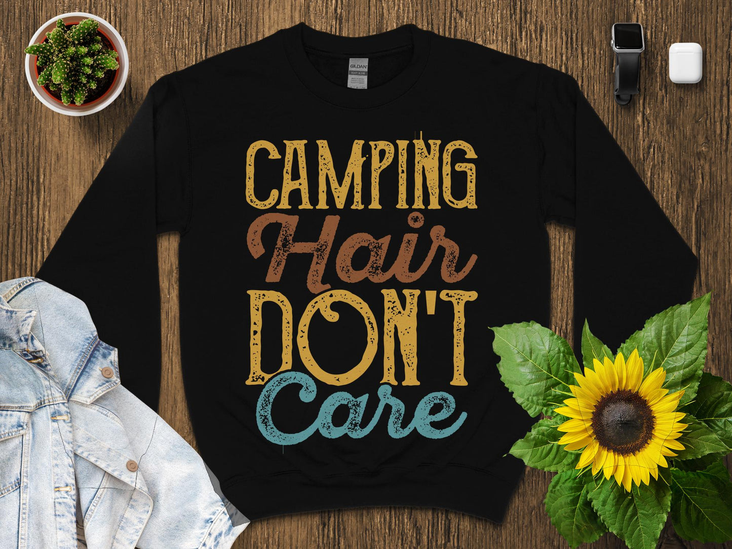 Black sweatshirt with "CAMPING HAIR DON'T CARE" text in distressed font.