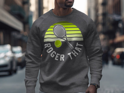 Gray sweatshirt with "ROGER THAT" text and tennis racket and ball graphic.