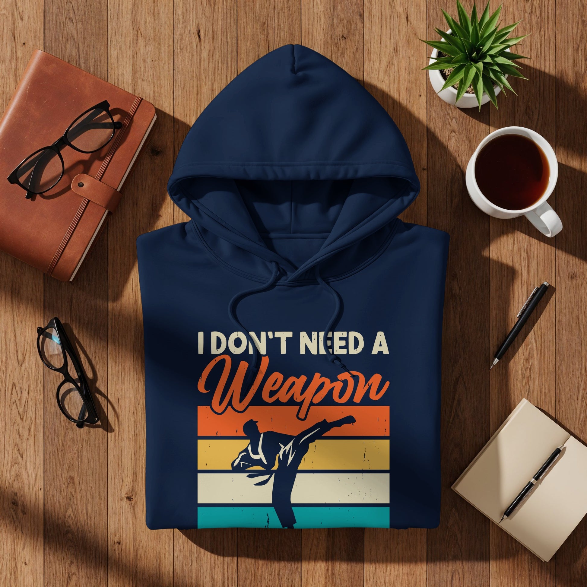 Navy hoodie with "I Don't Need a Weapon" text and karate silhouette.