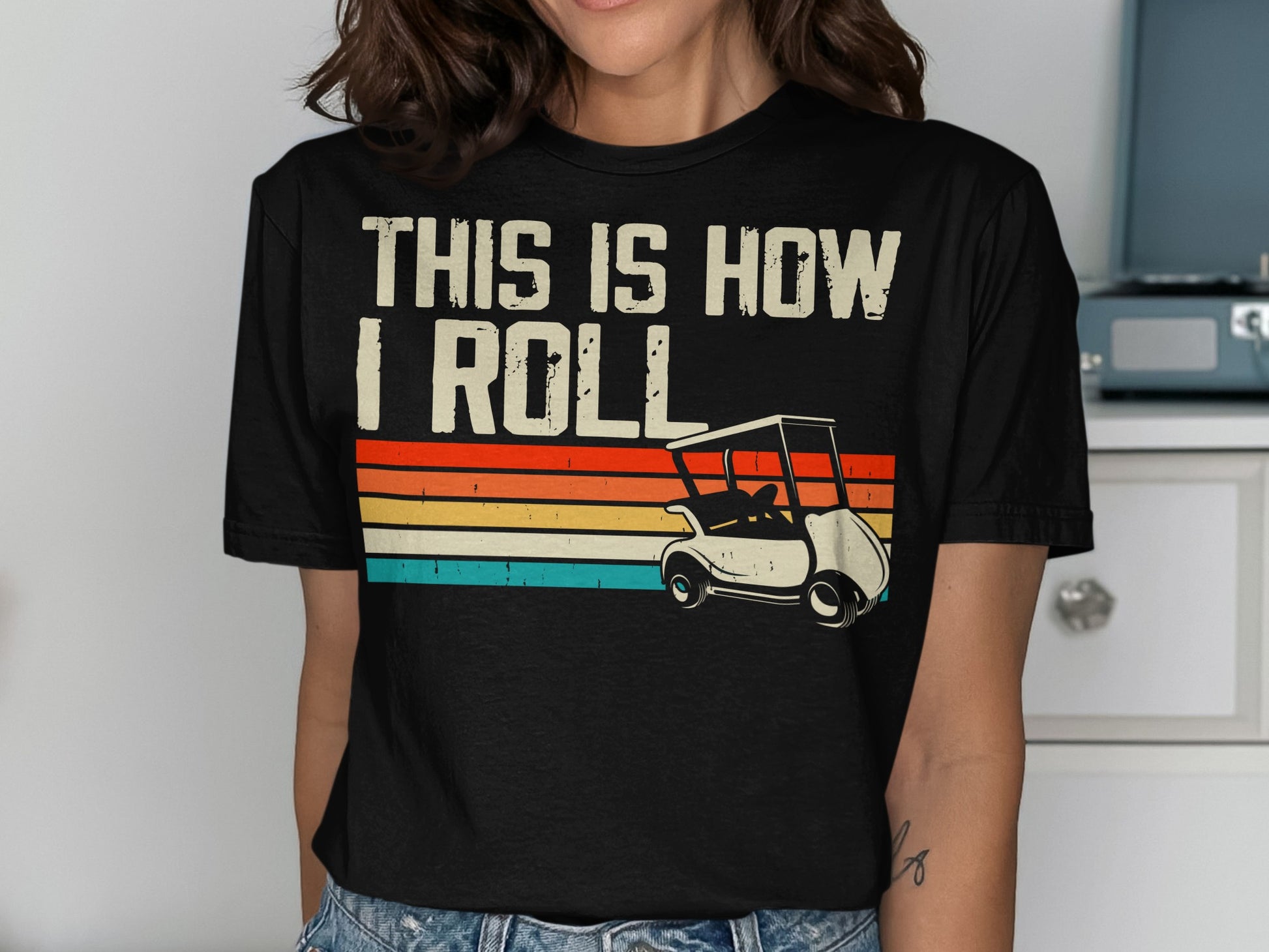 Black t-shirt with "THIS IS HOW I ROLL" and a golf cart graphic.