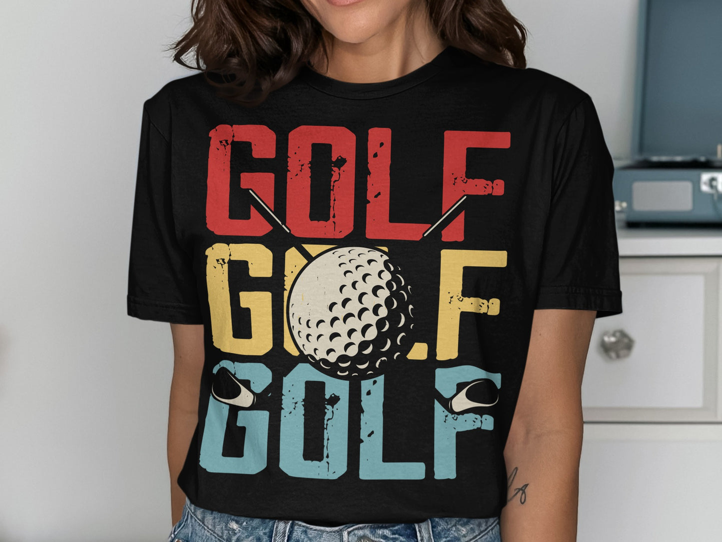 Retro GOLF text with a golf ball and tees graphic on a t-shirt.