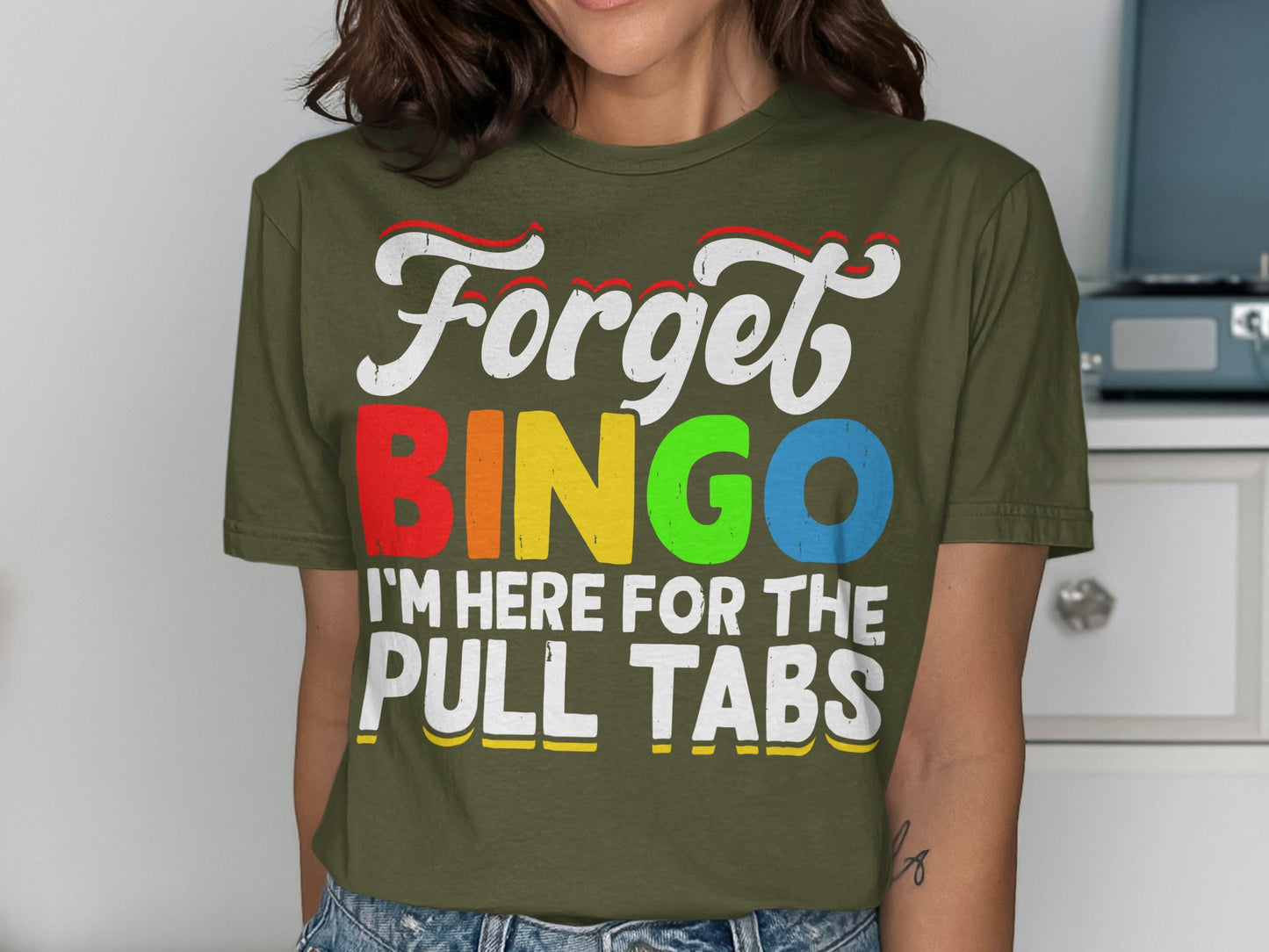 Olive green t-shirt with "Forget BINGO I'm here for the PULL TABS" in colorful text.