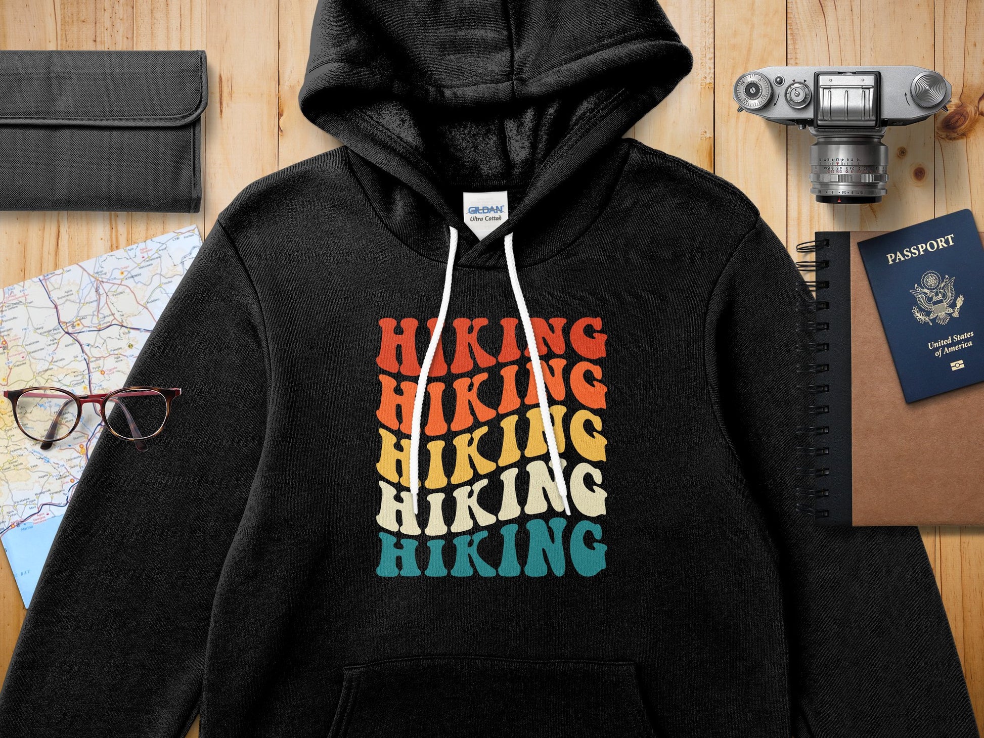 Black hoodie with "Hiking" text in colorful retro block letters.