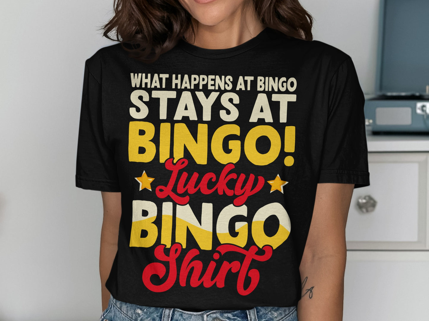 Black t-shirt with "WHAT HAPPENS AT BINGO! Lucky BINGO Shirt" text.