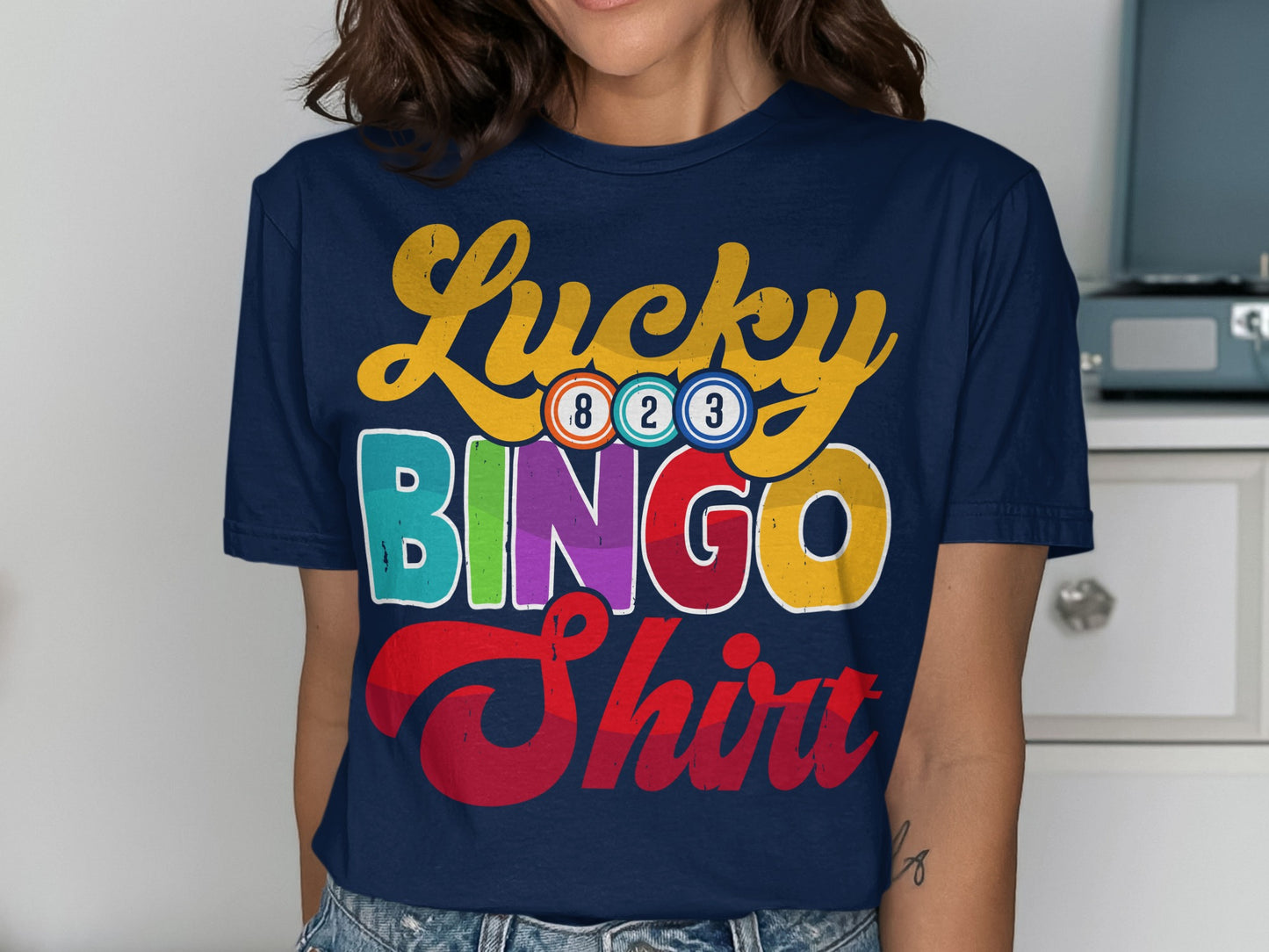 Navy t-shirt with "Lucky BINGO Shirt" in colorful text and bingo balls.