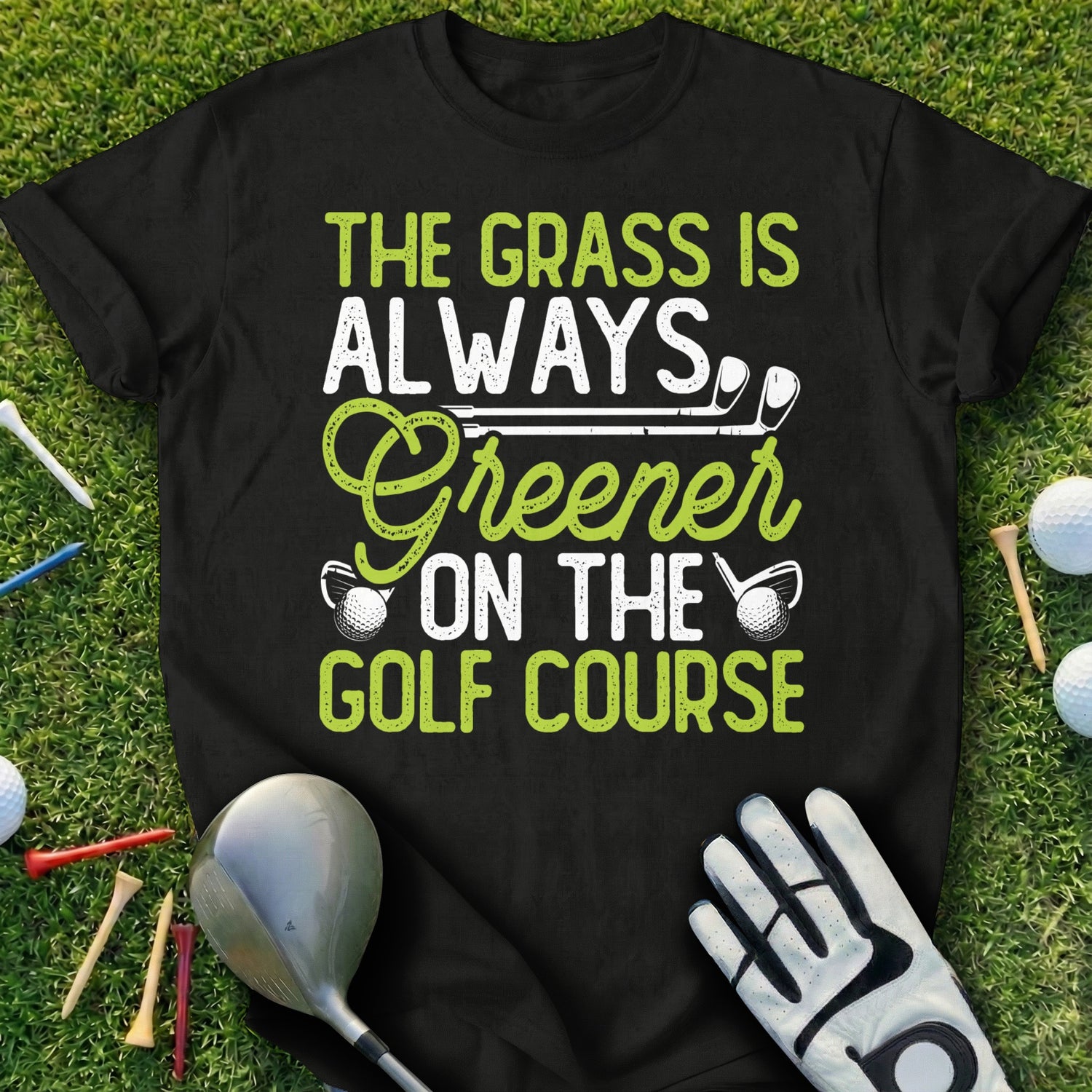Black t-shirt with "The Grass Is Always Greener On The Golf Course" text.