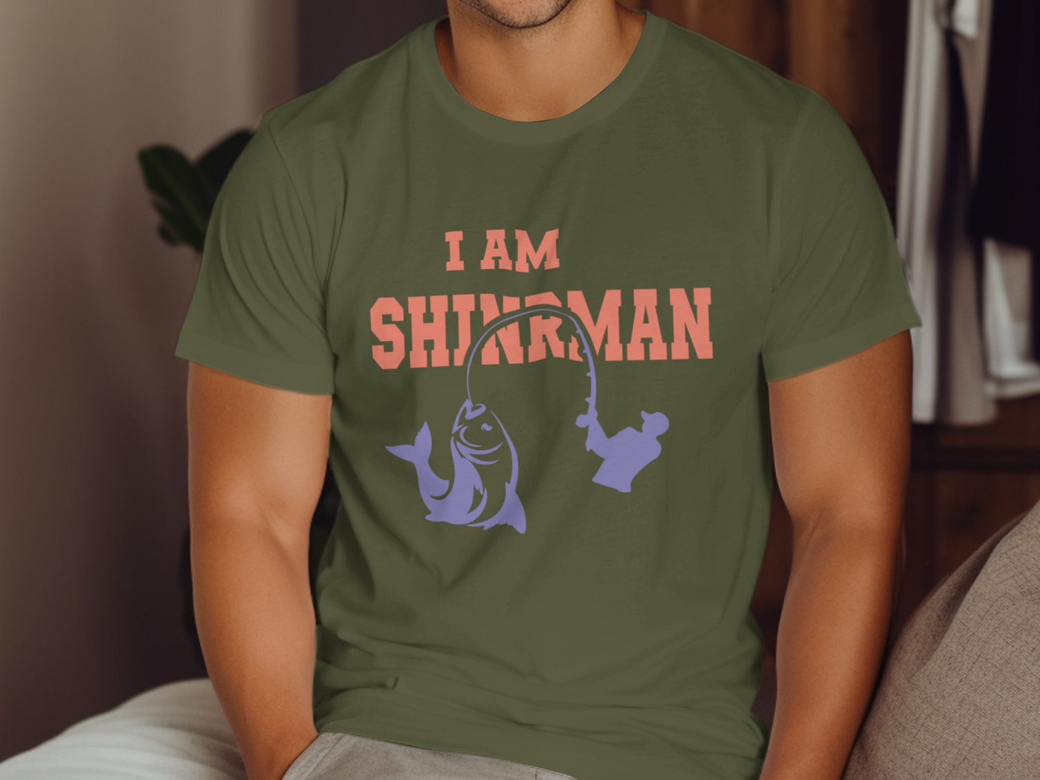 Olive t-shirt with "I AM SHINJIRUMAN" and fishing graphics.