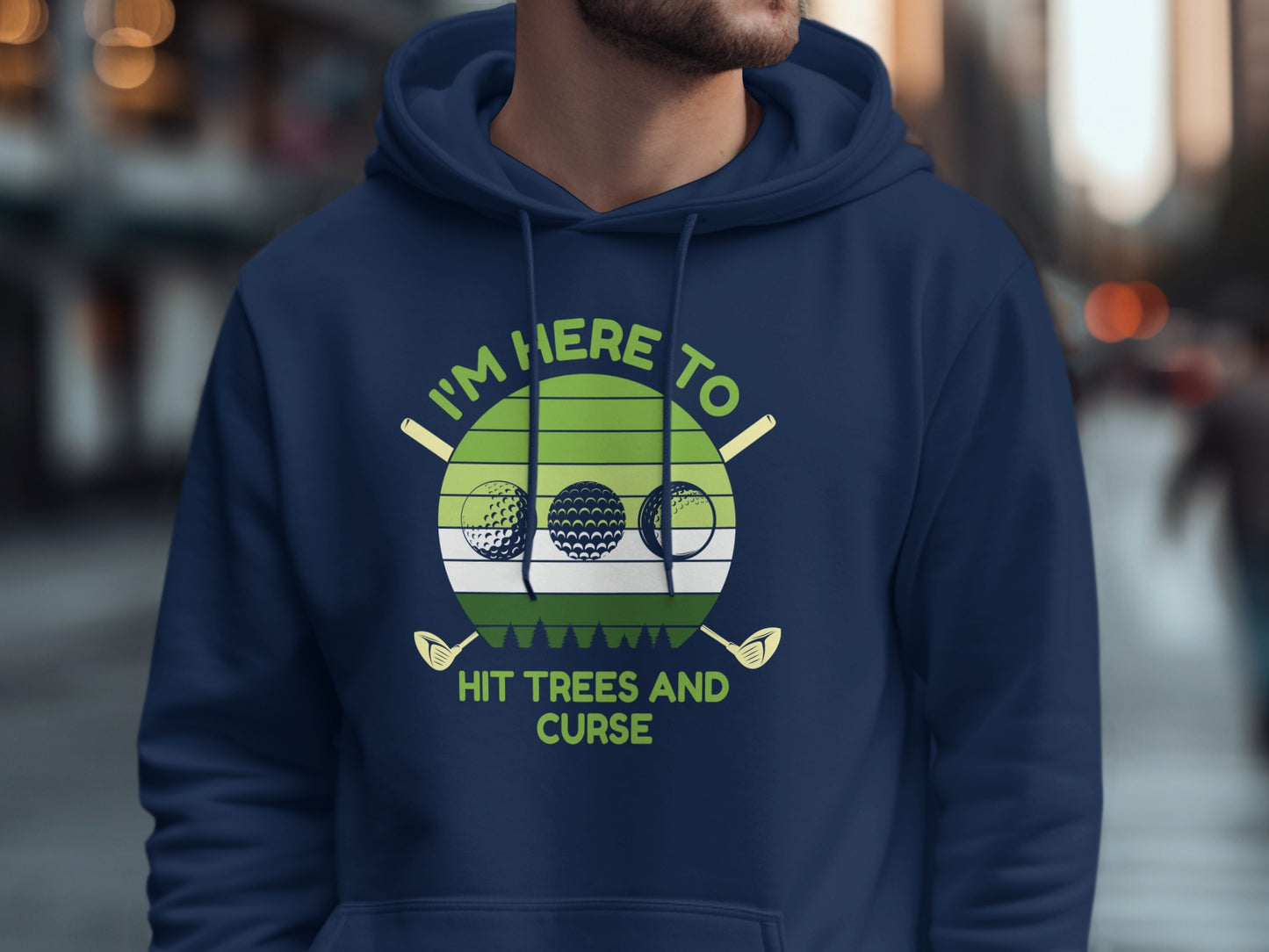 Navy hoodie with text "I'm Here To Hit Trees And Curse" and golf graphics.