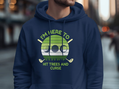 Navy hoodie with text "I'm Here To Hit Trees And Curse" and golf graphics.