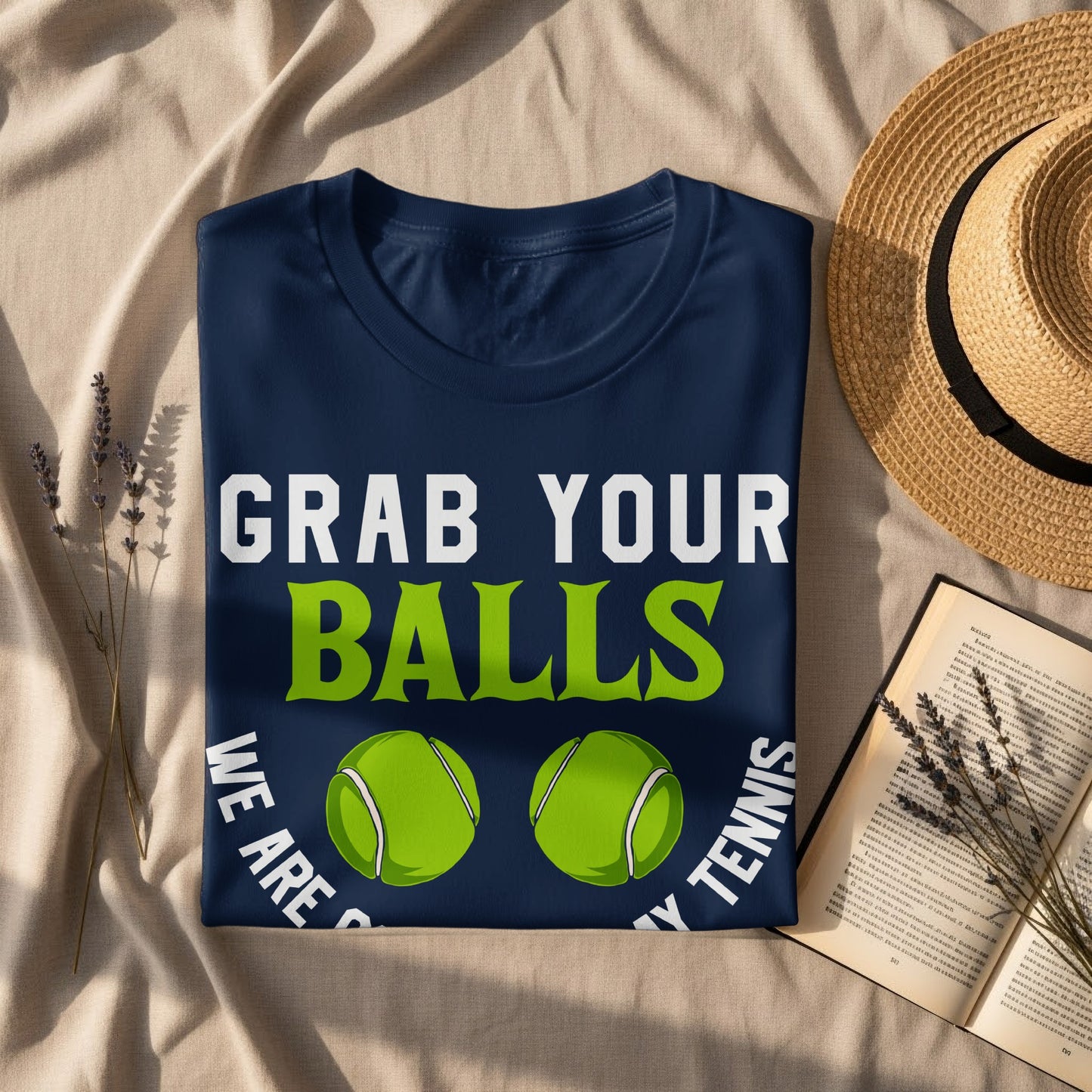 Navy t-shirt with "GRAB YOUR BALLS" and tennis balls.