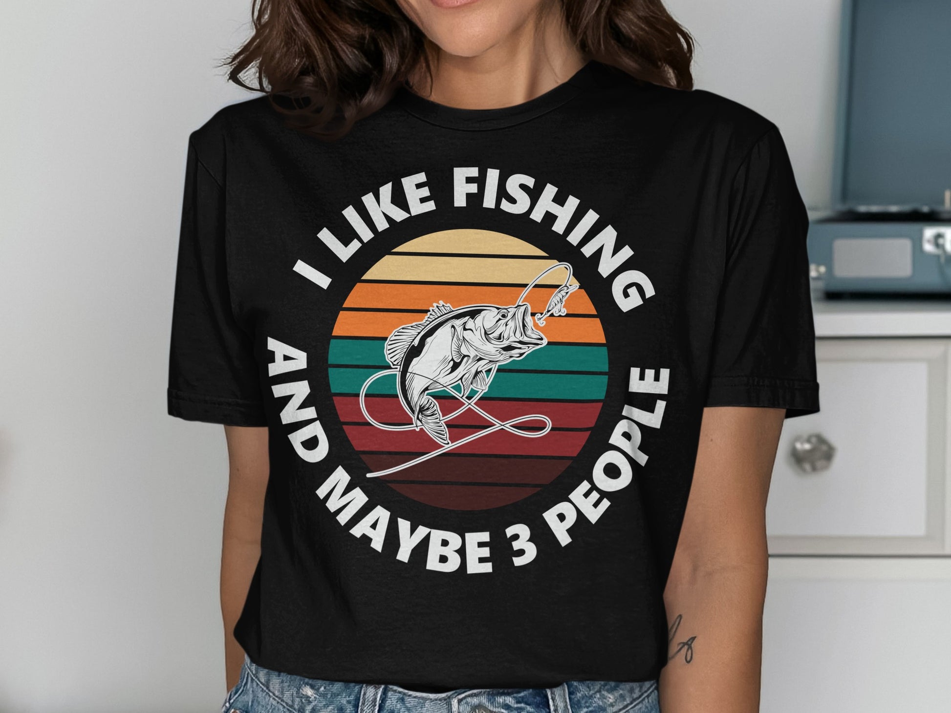 T-shirt with text "I LIKE FISHING AND MAYBE 3 PEOPLE" and a fish illustration.
