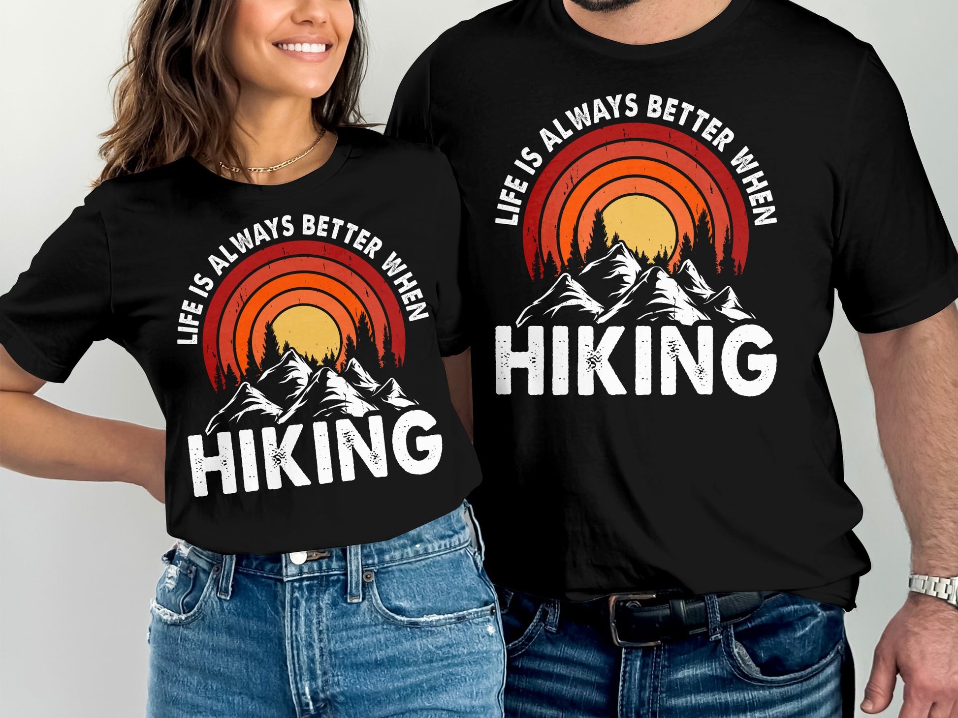 Couple wearing matching "Life is Always Better When Hiking" t-shirts with mountain sunset design.