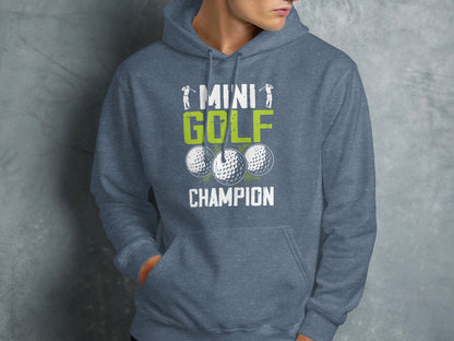 Grey hoodie with "Mini Golf Champion" text and three golf balls.