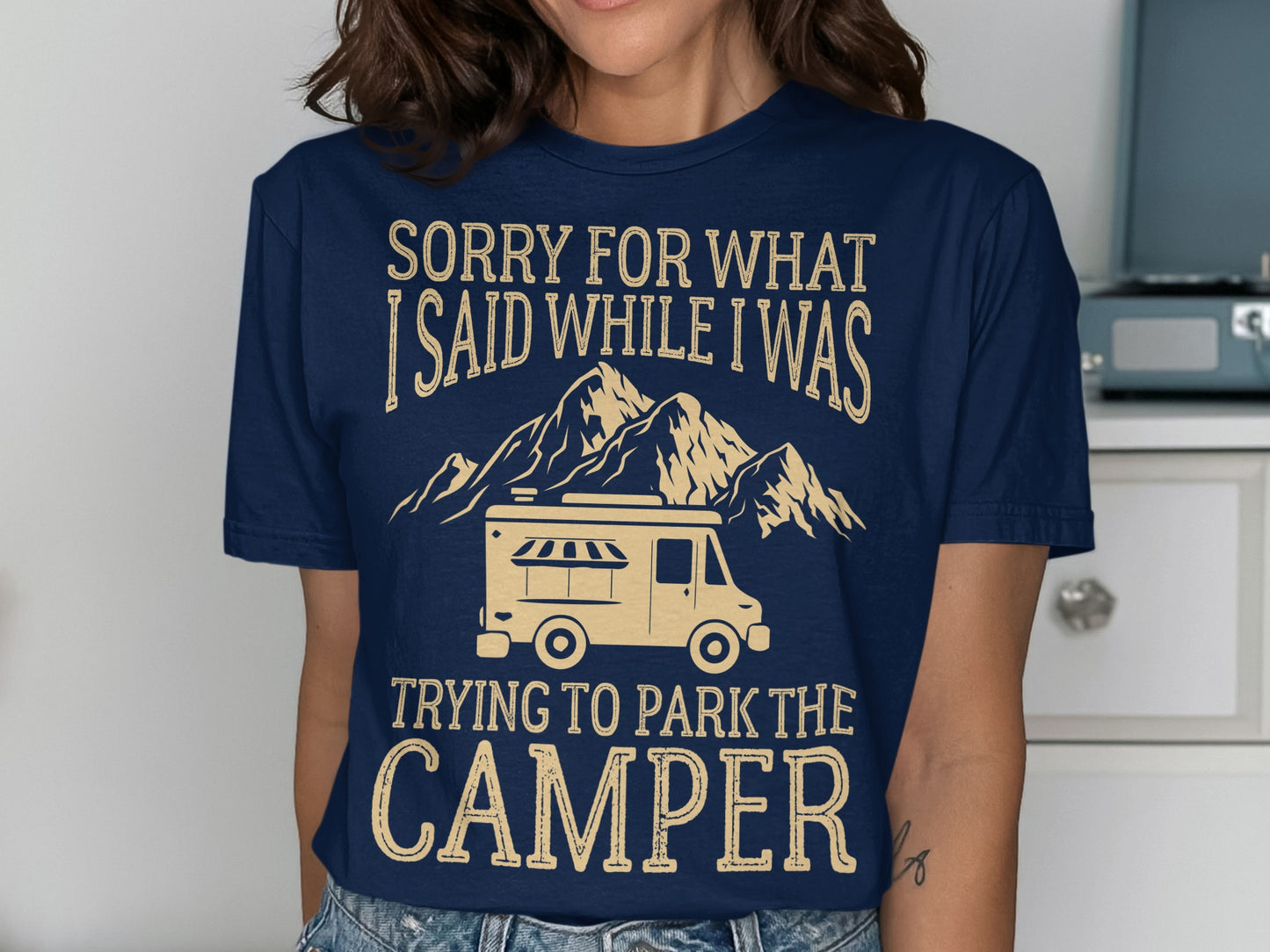 Navy t-shirt with text "SORRY FOR WHAT I SAID WHILE I WAS TRYING TO PARK THE CAMPER" and mountain graphic.