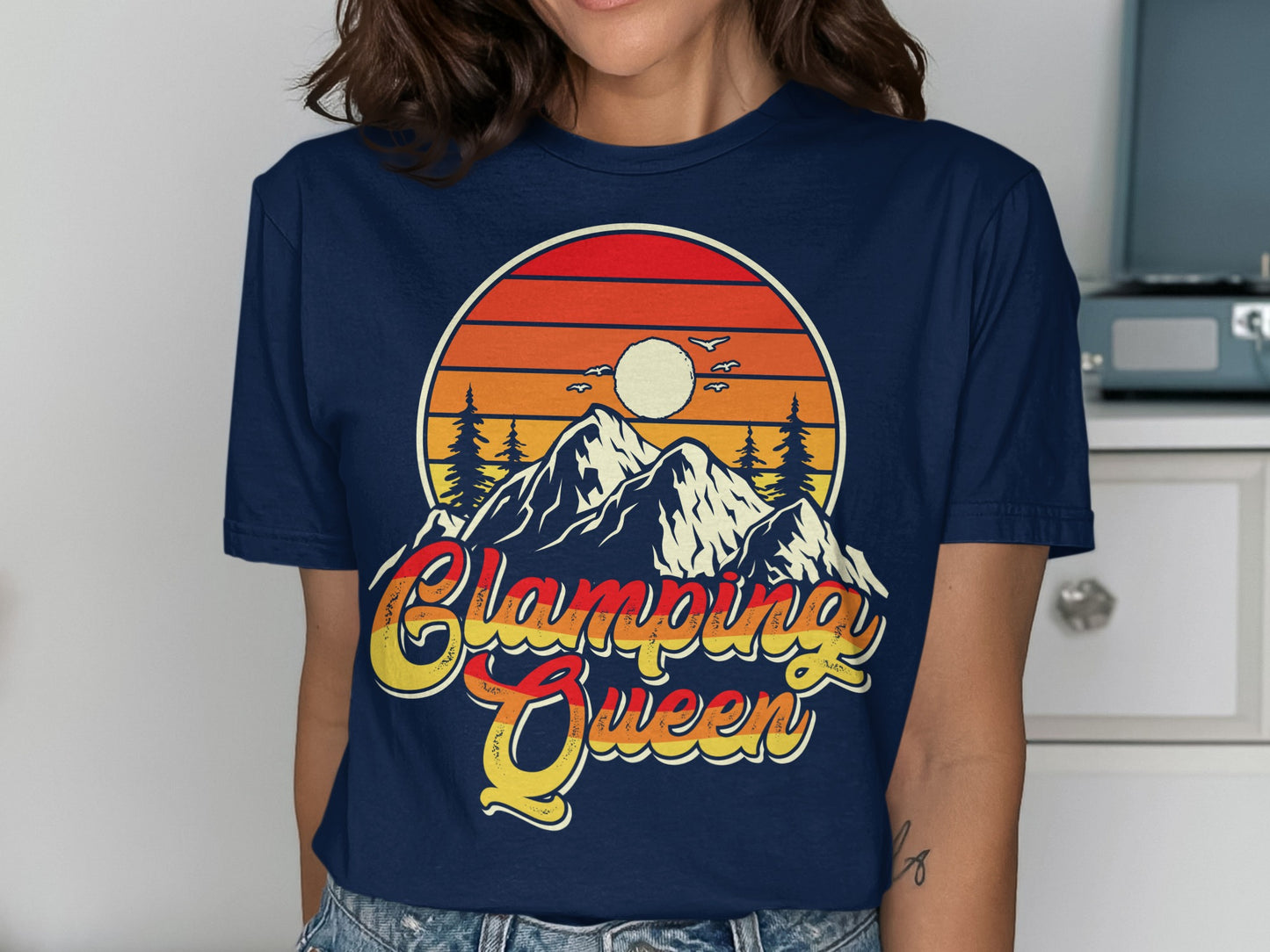 Navy t-shirt with "Glamping Queen" graphic featuring mountains, sunset, and trees.