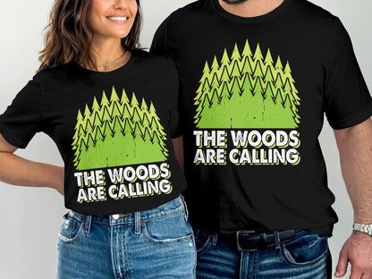 Black t-shirts with green pine trees and "The Woods Are Calling" text.