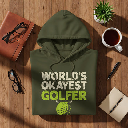 Olive green hoodie with "World's Okayest Golfer" text and golf ball graphic.