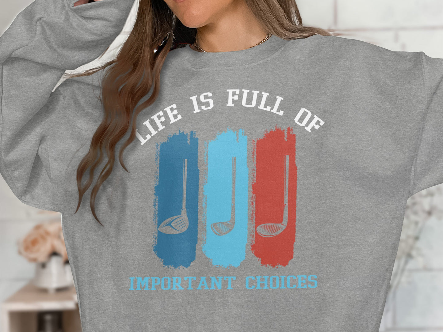 Grey sweatshirt with "Life is Full of Important Choices" and golf club graphic.