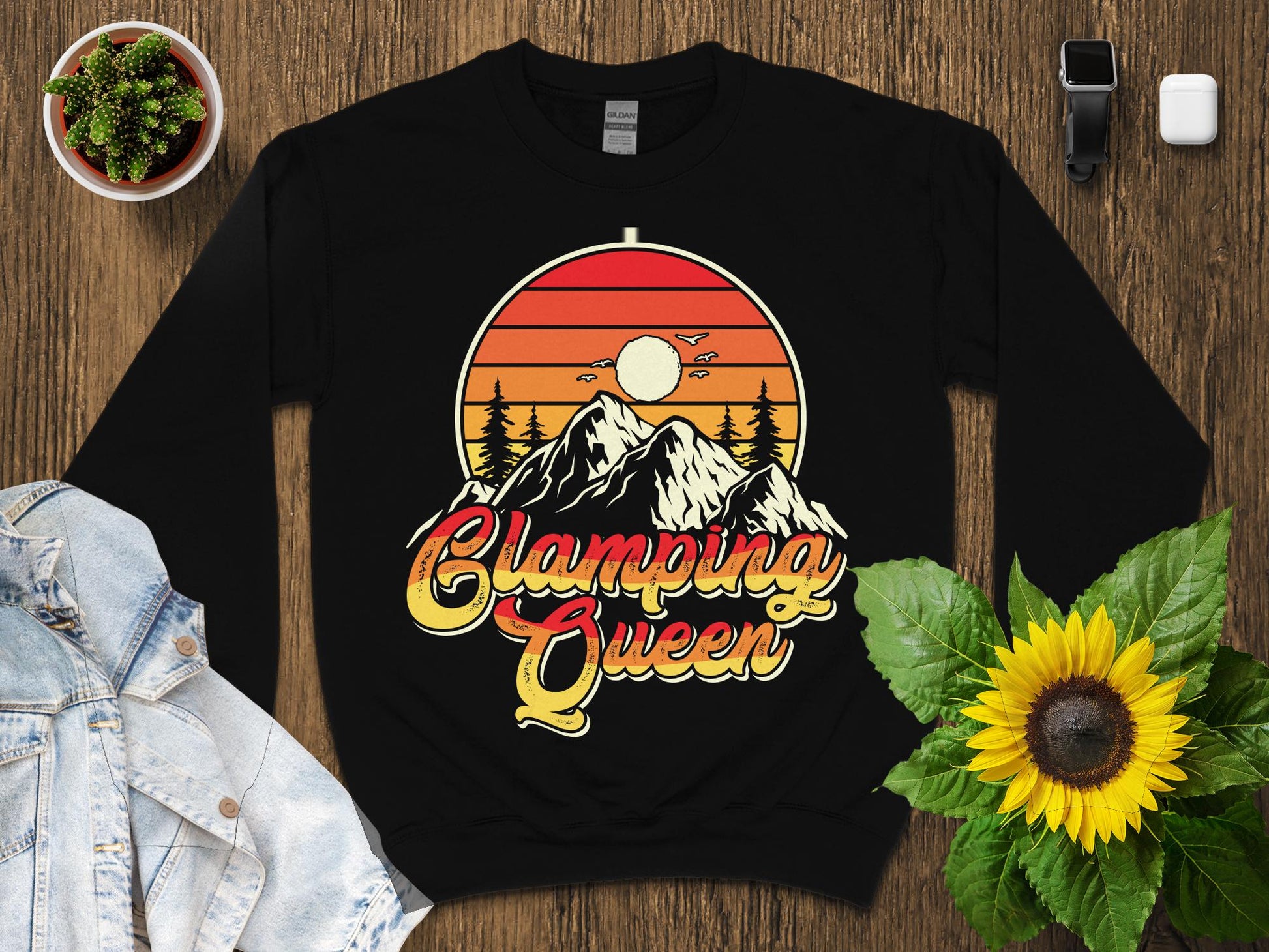 Black sweatshirt with "Camping Queen" sunset mountain graphic.