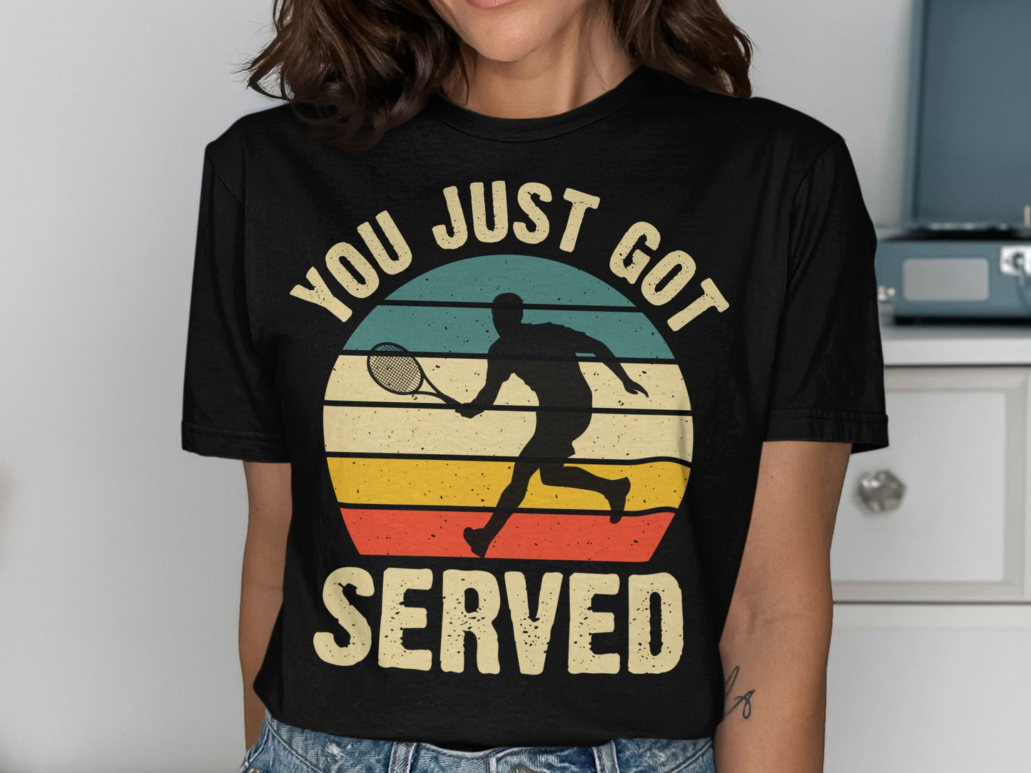 Black t-shirt with a silhouette of a tennis player and text "YOU JUST GOT SERVED".