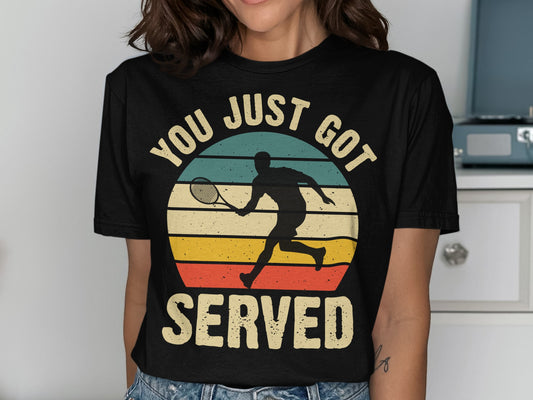 Black t-shirt with a silhouette of a tennis player and text "YOU JUST GOT SERVED".