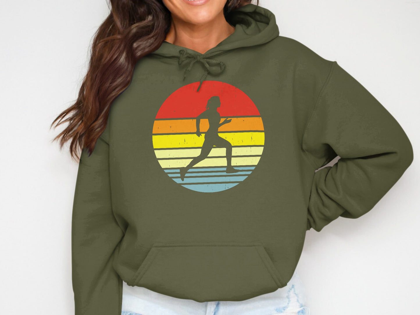 Olive green hoodie with a circular sunset graphic featuring a runner silhouette.