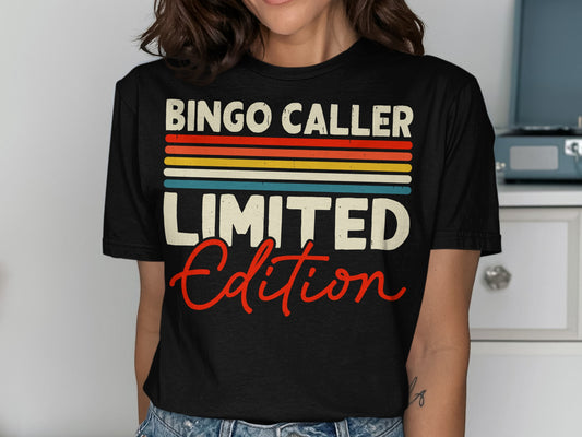 Black t-shirt with "BINGO CALLER LIMITED EDITION" in colorful stripes and red script.