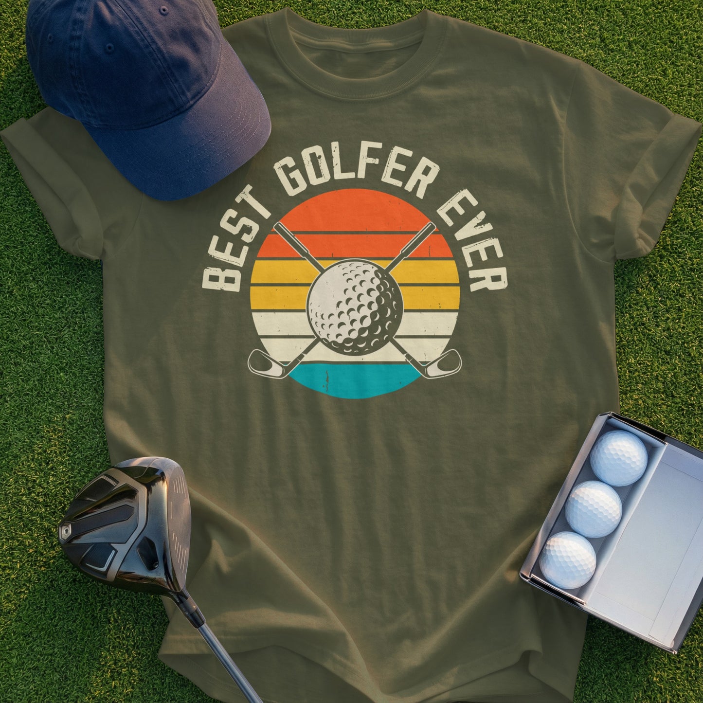 Olive t-shirt with "BEST GOLFER EVER" text and golf ball sunset graphic.