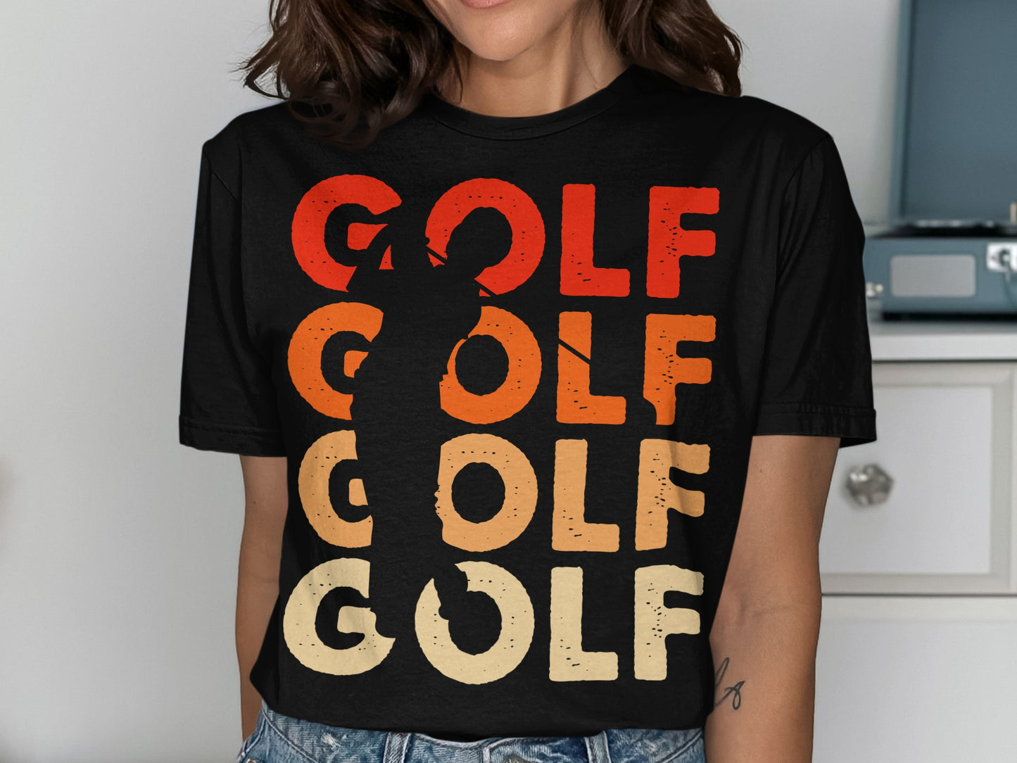 Black t-shirt with "GOLF" in large, retro-style orange and red text.