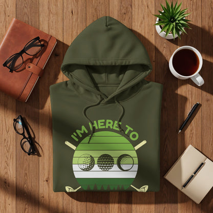 Olive green hoodie with "I'm here to" text and golf ball graphic.