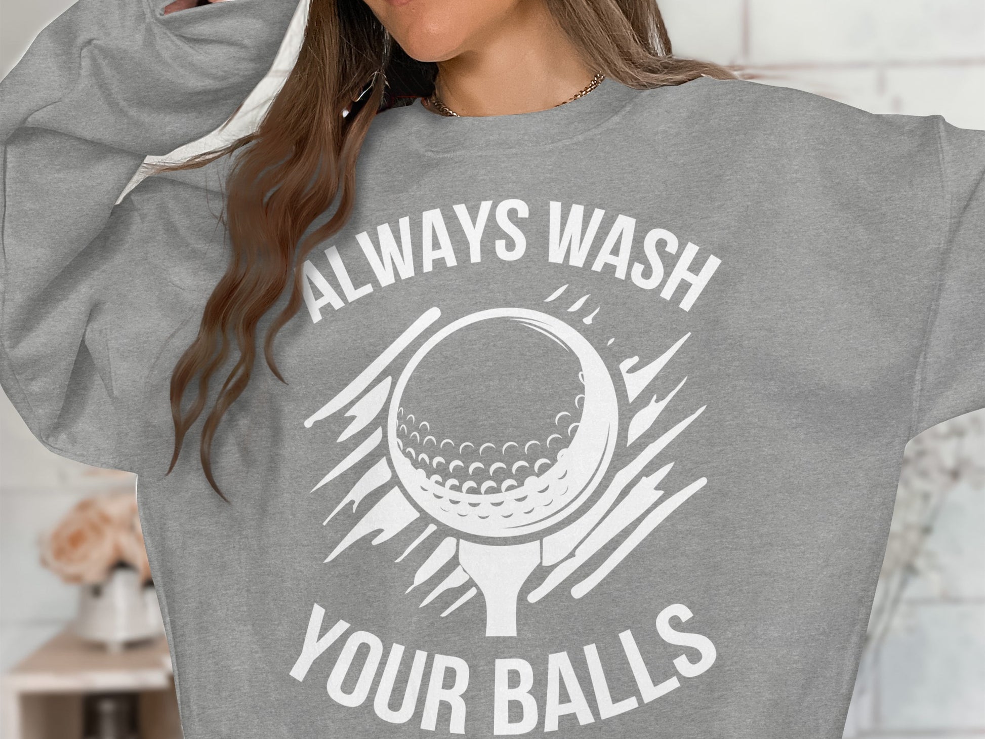 Gray sweatshirt with a graphic of a golf ball and tee, reading "Always Wash Your Balls".