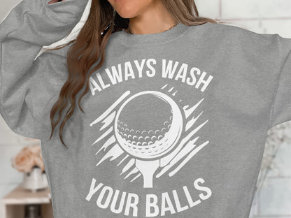 Gray sweatshirt with a graphic of a golf ball and tee, reading "Always Wash Your Balls".