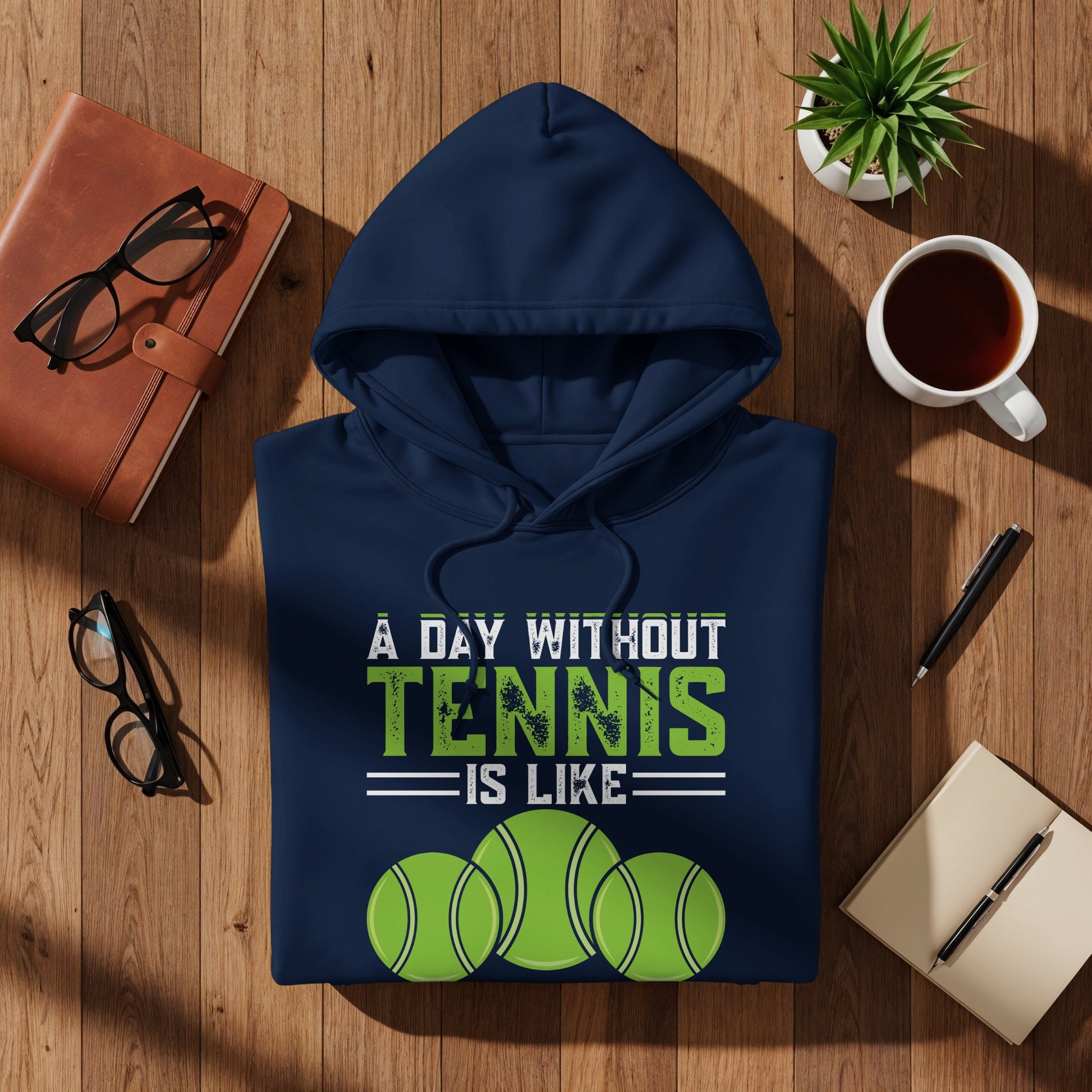 Navy hoodie with "A day without tennis is like" and three tennis balls.