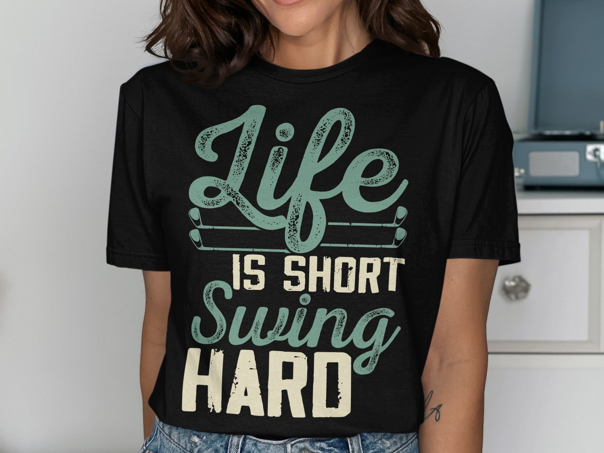 Black t-shirt with "Life Is Short Swing Hard" text and golf clubs.