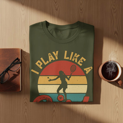 Olive green t-shirt with retro graphic of tennis player and text "PLAY LIKE A".
