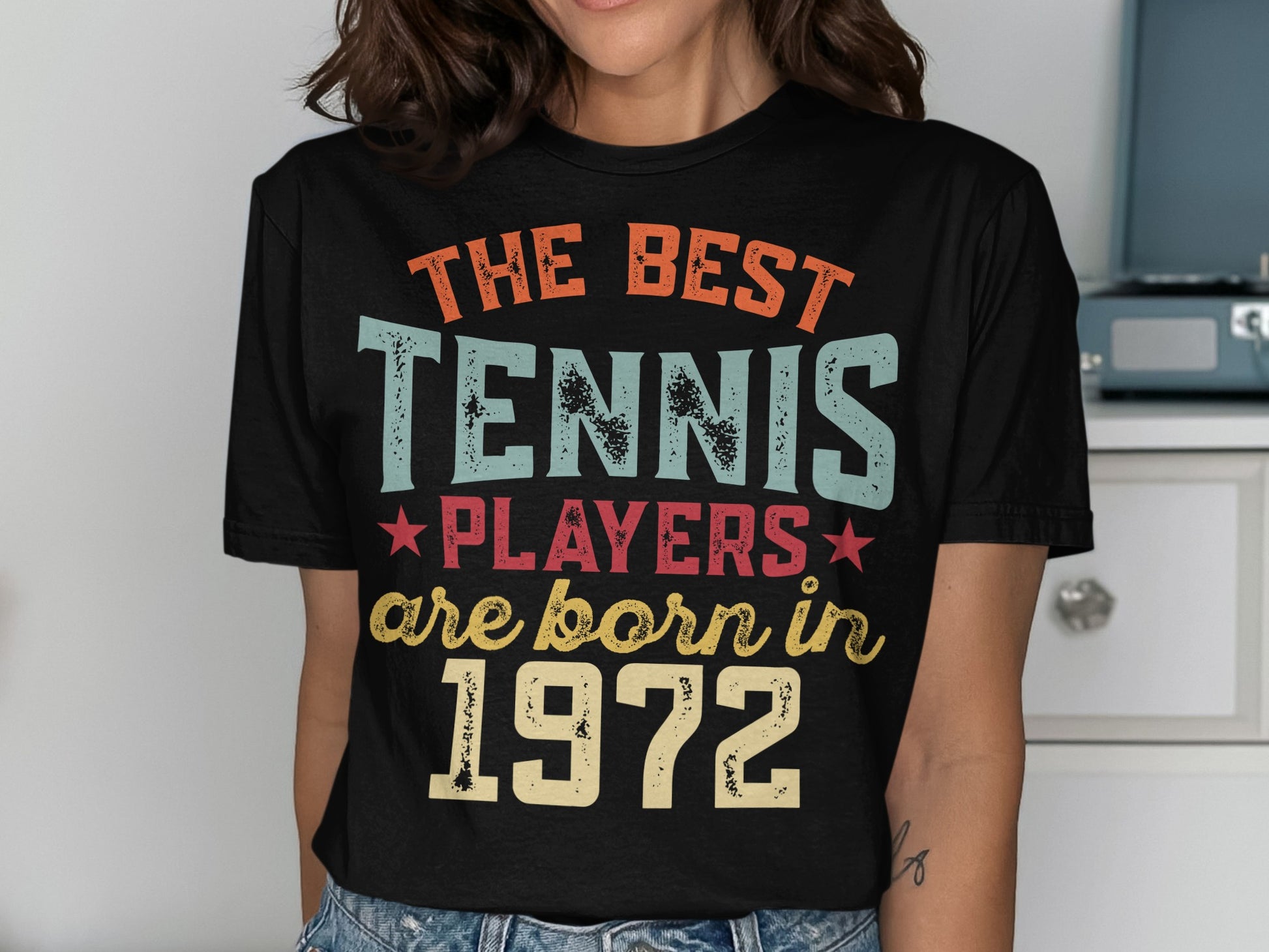 Black t-shirt with "The Best Tennis Players are Born in 1972" text.