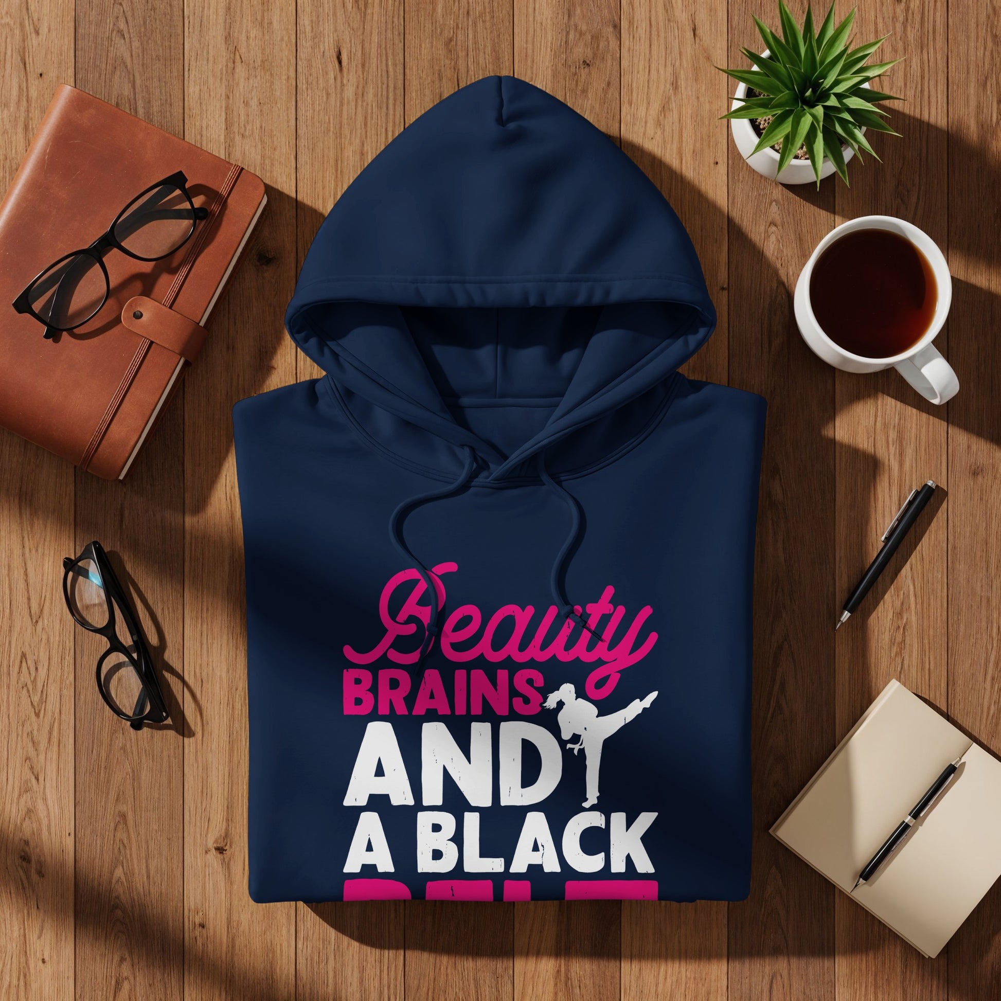 Dark blue hoodie with "Beauty BRAINS AND A BLACK BELT" text and martial artist graphic.