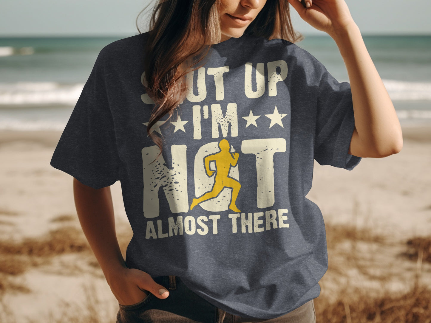 Dark t-shirt with "SHUT UP I'M ALMOST THERE" and a runner.